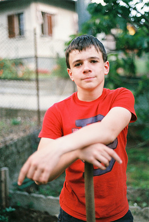 portrait of a male teenager with his arms resting on the handle
