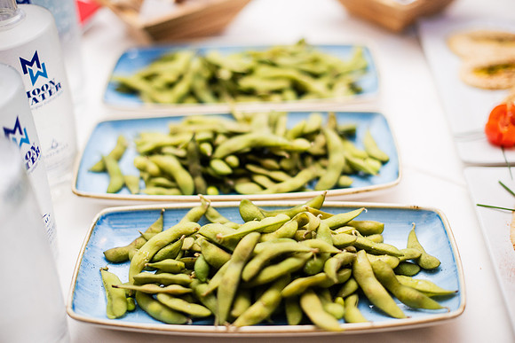 Delicious edamame served on blue plates at a casual dining event