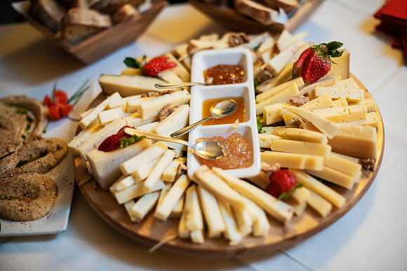 Delicious cheese platter with fresh strawberries and jams served